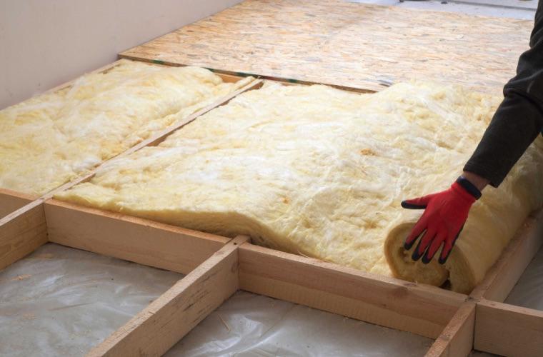 Hand installing new insulation